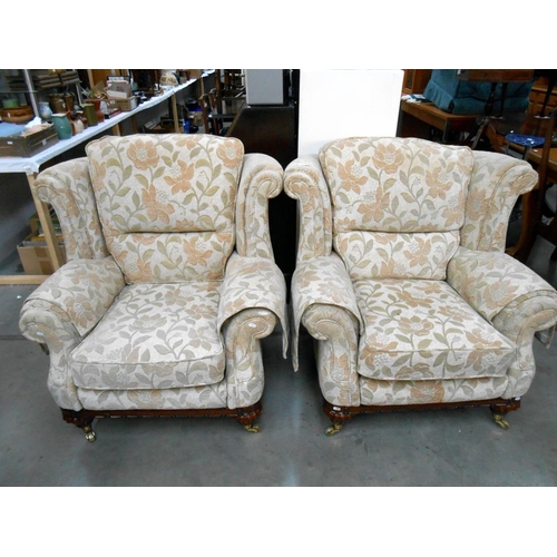 513 - A pair of cream floral pattern lounge chairs