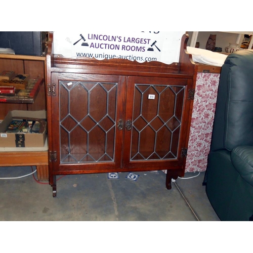 515 - A medium oak wall cupboard with leaded glass doors