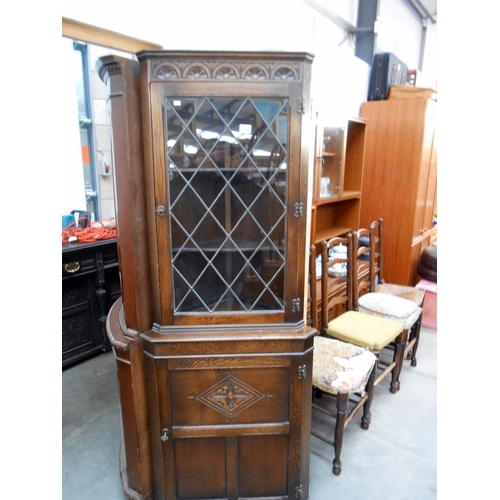 528 - A dark oak lead glass glazed corner cabinet, height 184cm