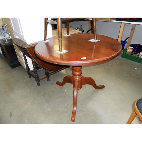 533 - A dark pine round kitchen table on centre column tripod base height 76cm, diameter 91cm