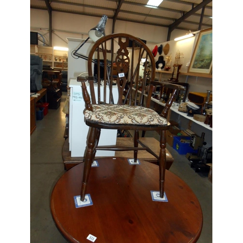 534 - A darkwood wheelback carver chair