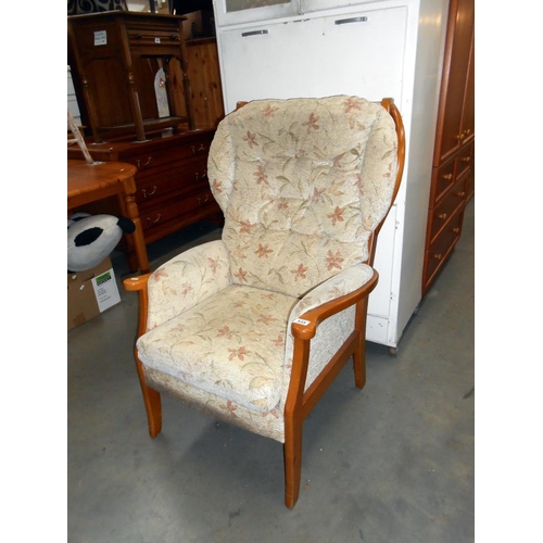 535 - A wood framed upholstered armchair