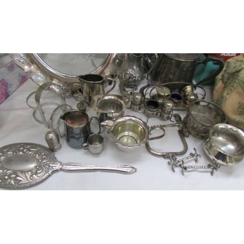 1155 - A mixed lot of silver plate including large trays, cruet sets etc.,