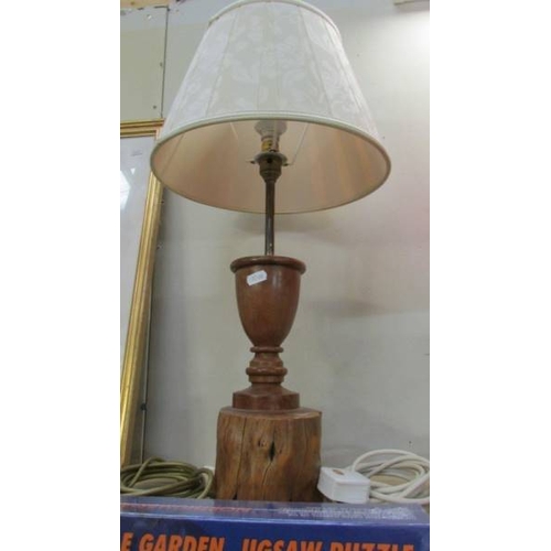 1157 - Three craftsman turned wooden table lamps with shades, approximate heights 57 - 65 cm.