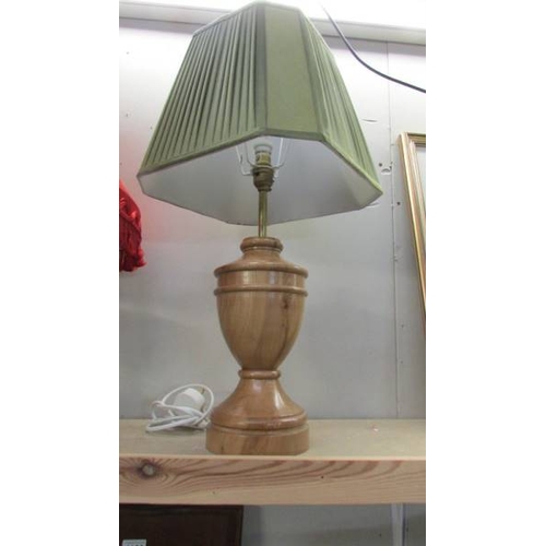 1157 - Three craftsman turned wooden table lamps with shades, approximate heights 57 - 65 cm.