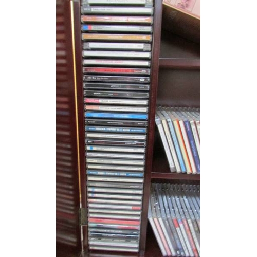 1199 - A large quantity of music CD's including Alfie Bo, Kathryn Jenkins, Kiri together with CD cabinet, i... 