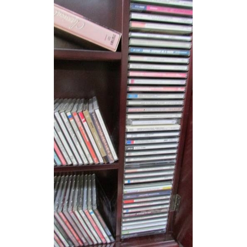 1199 - A large quantity of music CD's including Alfie Bo, Kathryn Jenkins, Kiri together with CD cabinet, i... 