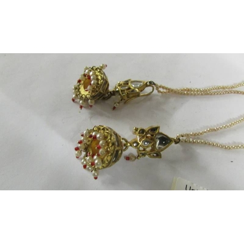 2117 - A pair of chandelier style pendant earrings with pearl safety chains, test as 18ct gold.