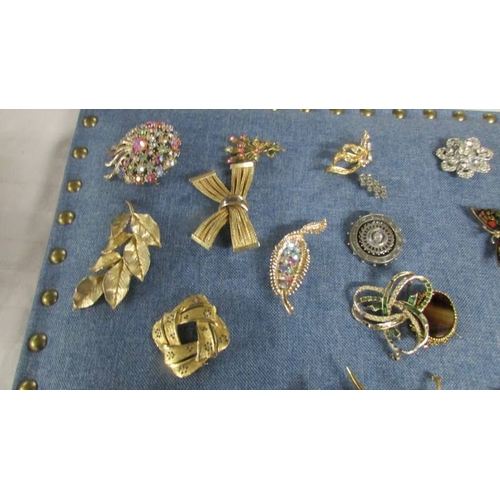 2119 - Approximately 40 vintage and mid 20th century brooches in various designs including a mermaid.