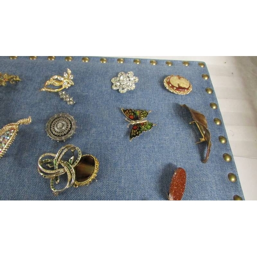 2119 - Approximately 40 vintage and mid 20th century brooches in various designs including a mermaid.