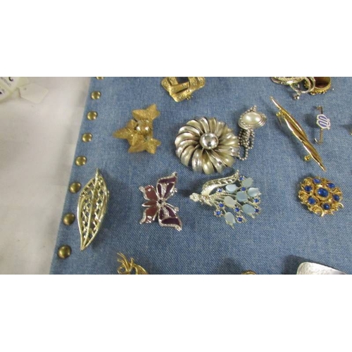 2119 - Approximately 40 vintage and mid 20th century brooches in various designs including a mermaid.