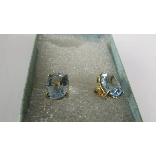 2120 - A pair of blue topaz stud earring sin 9ct gold (vibrant blue colour).