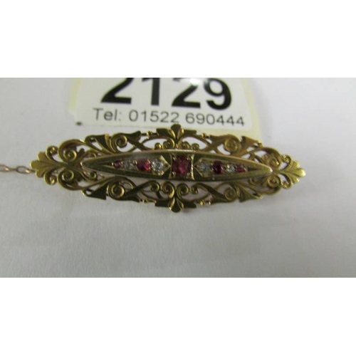 2129 - An antique diamond and ruby brooch in 15ct gold, total weight 5.4 grams.