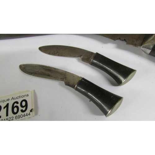 2169 - A superb quality antique kukri with skinning knives and another knife which is a/f.