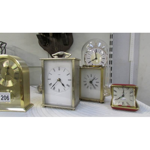 1206 - A mixed lot of modern clocks including a wall clock, anniversary, carriage clocks etc.,