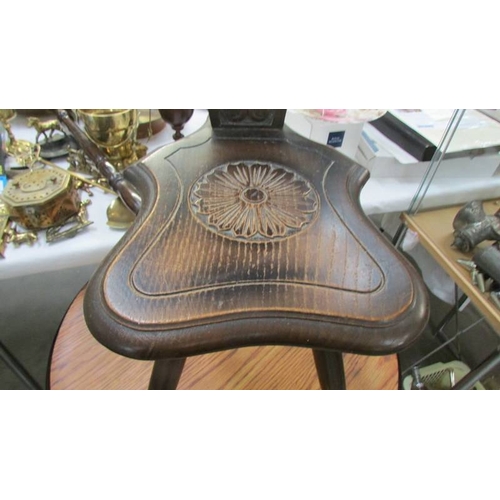 1248 - A dark oak carved spinning chair