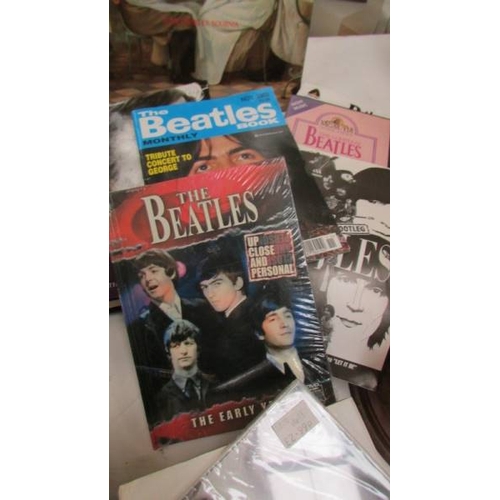 1262 - A mixed lot of Beatles memorabilia including CD, video, books, cards etc.,