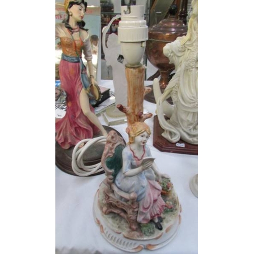 1263 - A figural table lamp and 4 assorted figures.