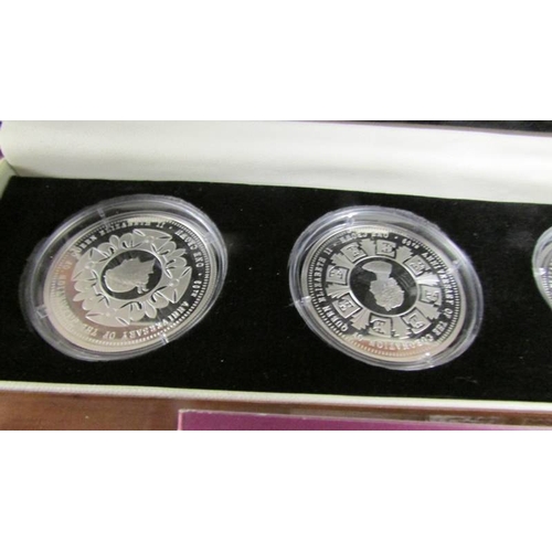 2134 - A cased set of four 60th anniversary of the coronation of Queen Elizabeth II silver coins featuring ... 