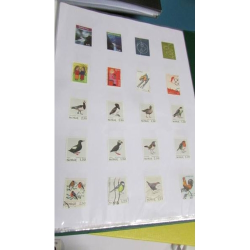 2139 - Ten albums of stamps including Poland, Szechoslovakia, Singapore, Malasia etc.,