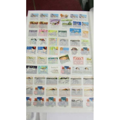 2140 - Five large stock books of stamps including Canada, Commonwealth, Australia etc.,