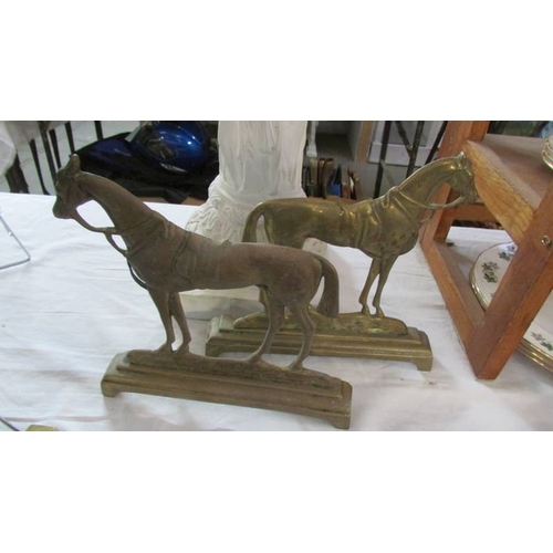 1282 - A Victorian brass 'Home Sweet Home' trivet top and left and right facing brass horse door stops.