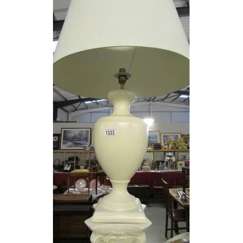 1333 - A cream pottery table lamp with shade on a plaster pillar, lamp needs rewiring, (pillar 64.5 cm and ... 