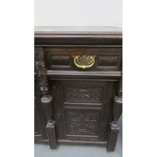 1366 - A carved dark wood stained sideboard.