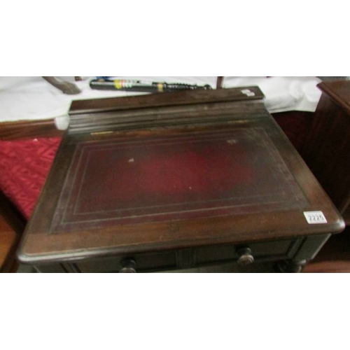 2225 - A mahogany writing table with lift up top.