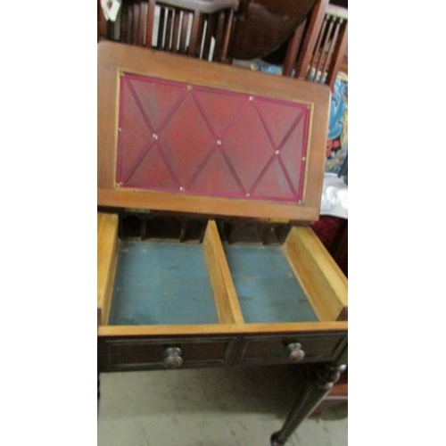 2225 - A mahogany writing table with lift up top.