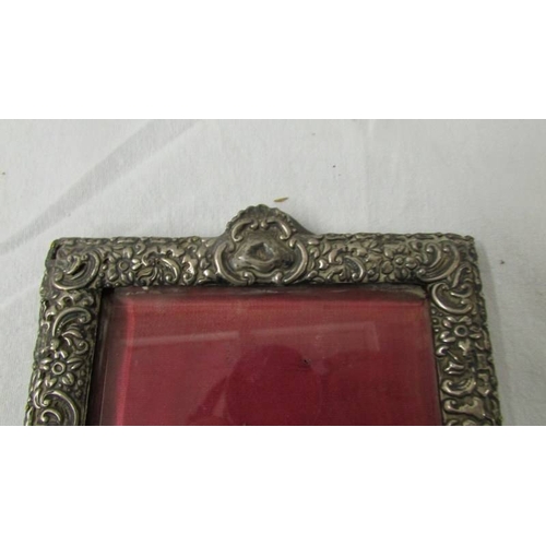 2236 - A hall marked silver photo frame with bevelled glass, missing back stand.