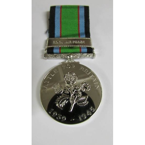 2240 - A boxed 'Battle of Britain' medal bar 'Royal Air Force' with a National Service Medal.