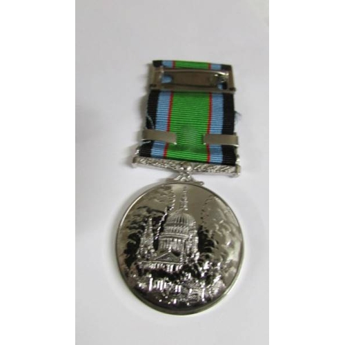 2240 - A boxed 'Battle of Britain' medal bar 'Royal Air Force' with a National Service Medal.