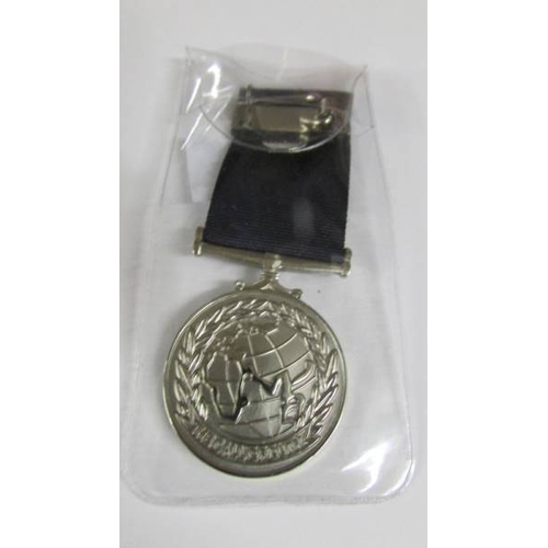 2241 - A boxed U.S.A medal with a boxed Suez Canal Zone medal with bar 'Suez Landings' (engraved personally... 