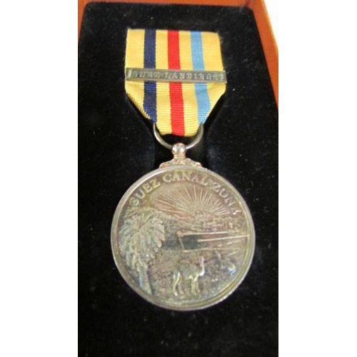 2241 - A boxed U.S.A medal with a boxed Suez Canal Zone medal with bar 'Suez Landings' (engraved personally... 