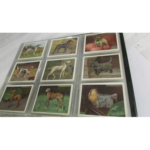 2261 - An album of cigarette cards including Players Dogs, Treasures of Britain, Famous Beauties, Senior Se... 