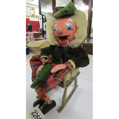 2266 - A vintage Scotsman puppet (no strings) sitting on a brass rocking chair.