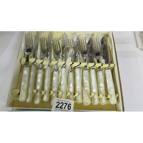 2276 - A boxed set of fish knives and forks and other cutlery.