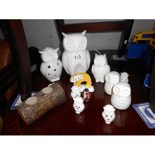 312 - A collection of white porcelain owl ornaments, candles & salt & pepper pots etc.