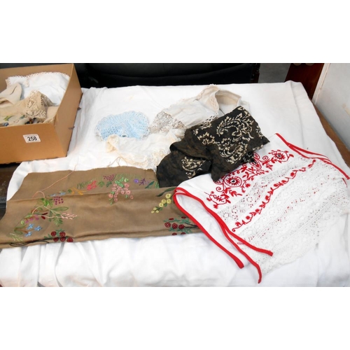 258 - A box of vintage textiles including embroidered household linens. mats & handkerchiefs