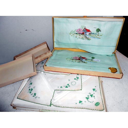 258 - A box of vintage textiles including embroidered household linens. mats & handkerchiefs