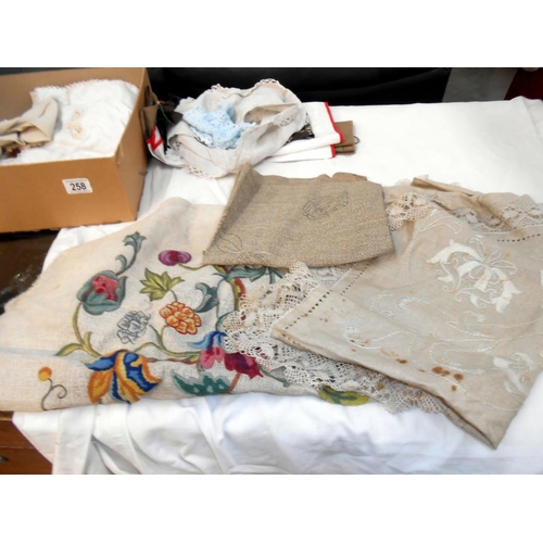 258 - A box of vintage textiles including embroidered household linens. mats & handkerchiefs