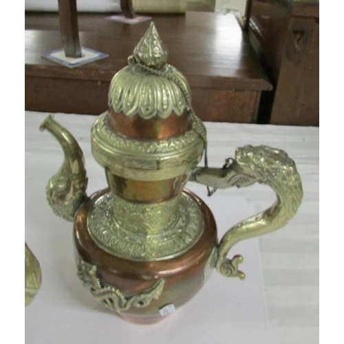 2282 - Two copper and white metal Tibetan teapots, 20th century, 28 and 23 cm tall.