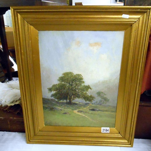 2184 - A gilt framed oil on board rural scene, signed but indistinct.