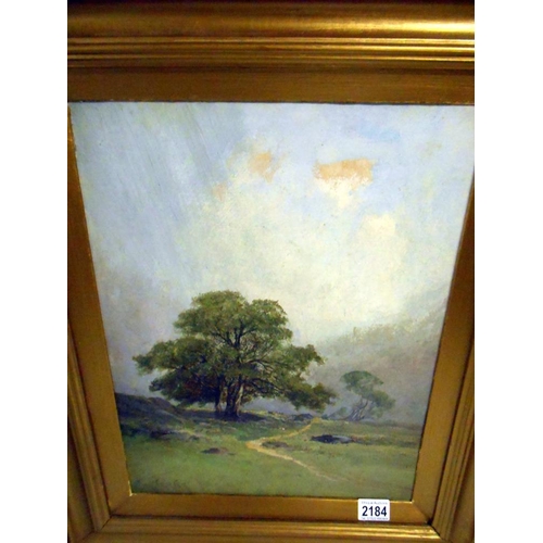 2184 - A gilt framed oil on board rural scene, signed but indistinct.