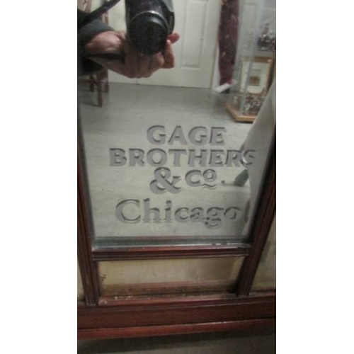 2371 - A mahogany cabinet with bevelled glass lettered door 'Cage Bros. Chicago'.