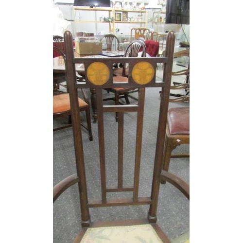 2423 - An Art Nouveau inlaid elbow chair in good condition.