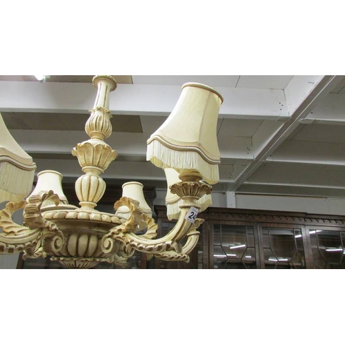 2459 - A large 6 arm wooden chandelier complete with ceiling rose, 71 cm diameter x 80 cm deep.