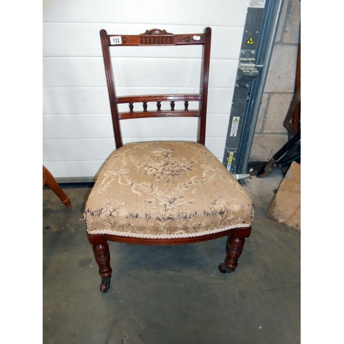 132 - A Victorian nursing chair on casters