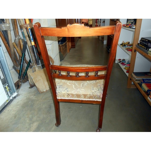 132 - A Victorian nursing chair on casters